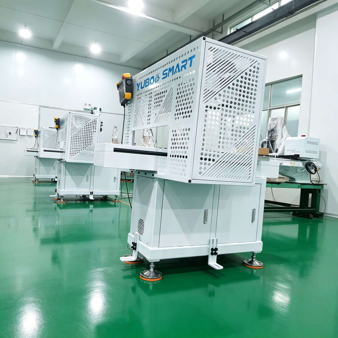 Multiple Yubao CNC center robot arms being assembled and debugged in factory workshop