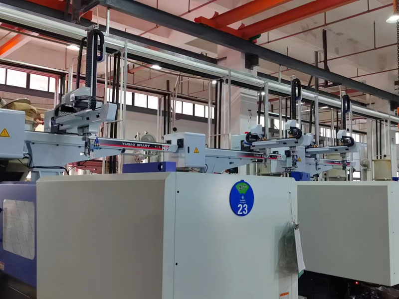 Yubao Smart industrial robot arms in clean injection molding factory workshop